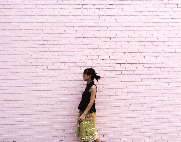 Namiko is an experienced English to Japanese translator and she is standing in front of the pink wall